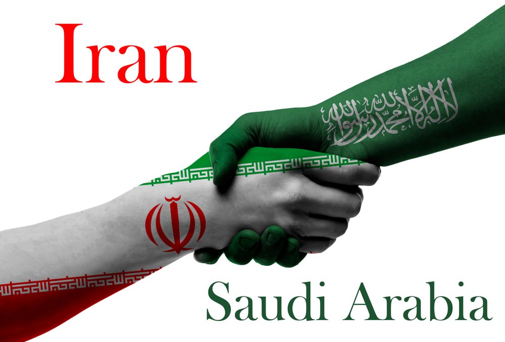 Saudi Arabia and Iran flags printed on the hand-shaking gesture